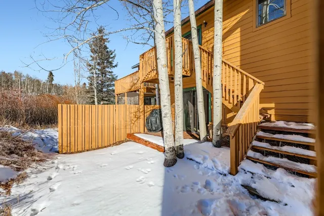 a view of a house with a wooden deck