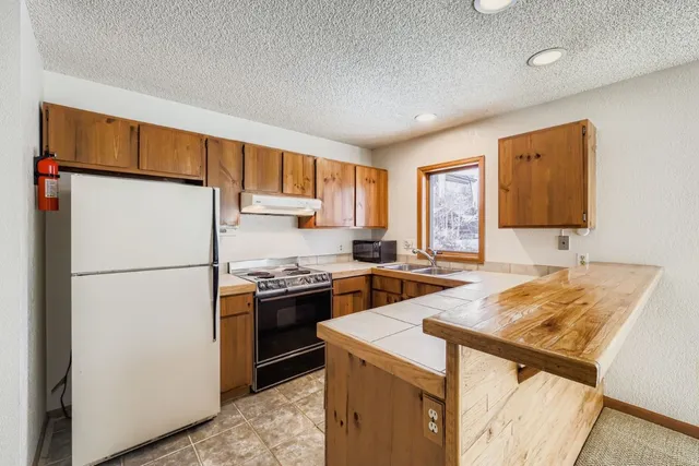 a kitchen with stainless steel appliances granite countertop a sink and cabinets