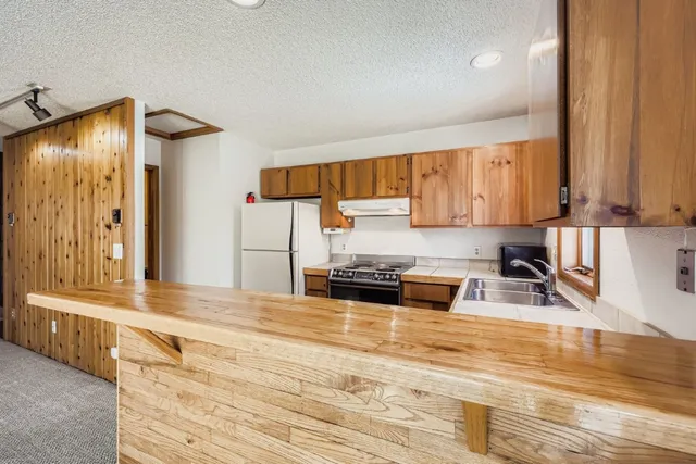 a view of an empty room with a fireplace