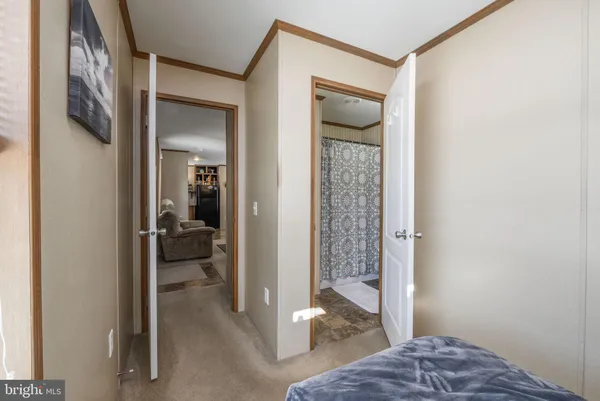 a bedroom with a bed and a glass door