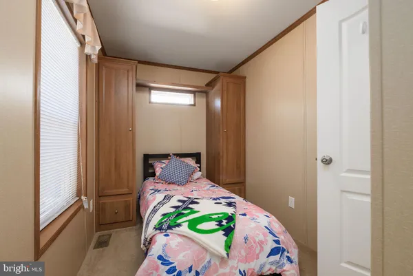 a bedroom with a bed and a window in it