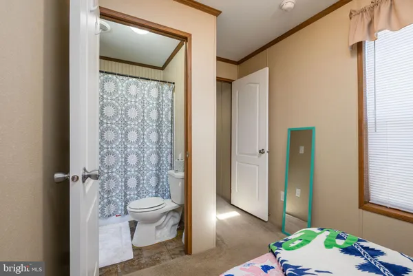 a bathroom with a toilet a sink and a shower