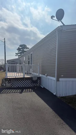a view of a house with a wooden deck