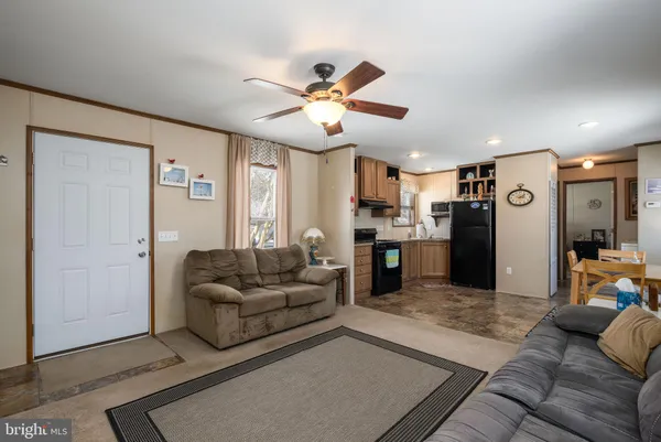 a living room with furniture and kitchen view