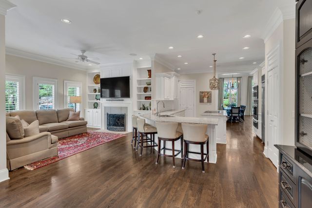 a kitchen with stainless steel appliances kitchen island granite countertop a refrigerator and a stove top oven