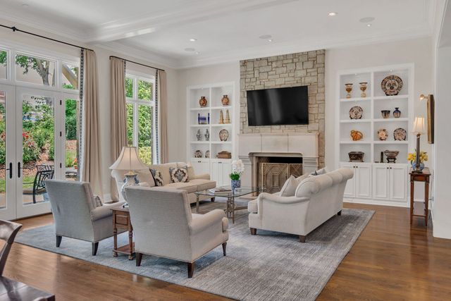 a bedroom with bed tv and a chandelier