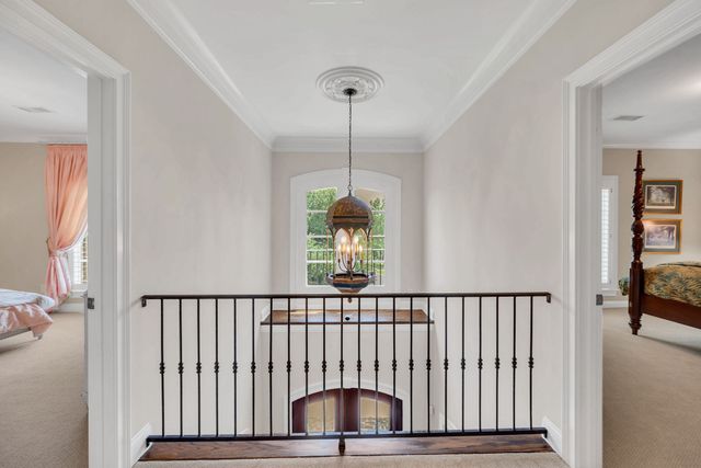 a patio with a table and chairs and potted plants