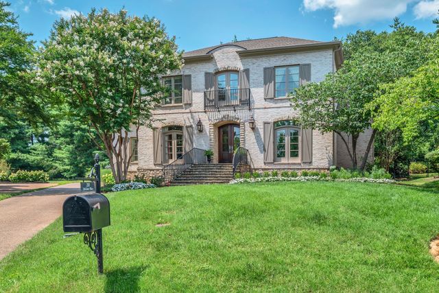 a front view of a house with a yard table and chairs