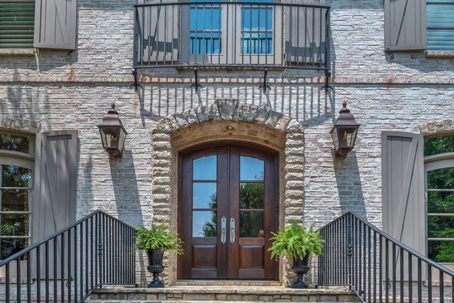 a front view of a house with potted plants