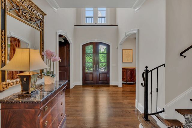 a view of a chairs and a table in the balcony