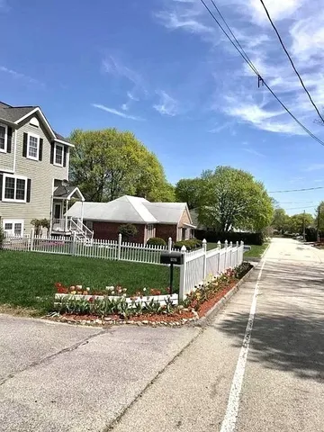 a view of a house with a yard and garden