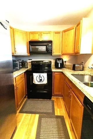 a kitchen with a sink a stove and cabinets