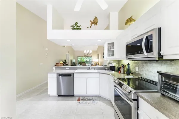 a kitchen with a sink cabinets and stainless steel appliances