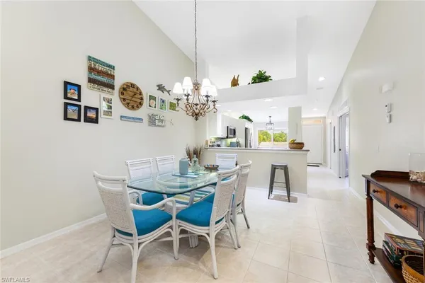 a view of a dining room with furniture and chandelier
