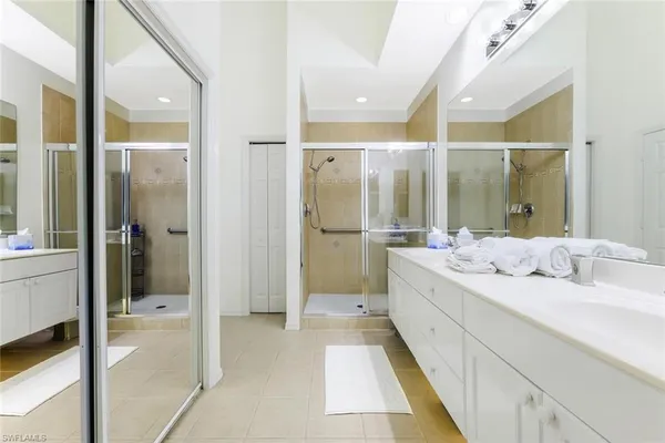a bathroom with a granite countertop sink mirror and shower