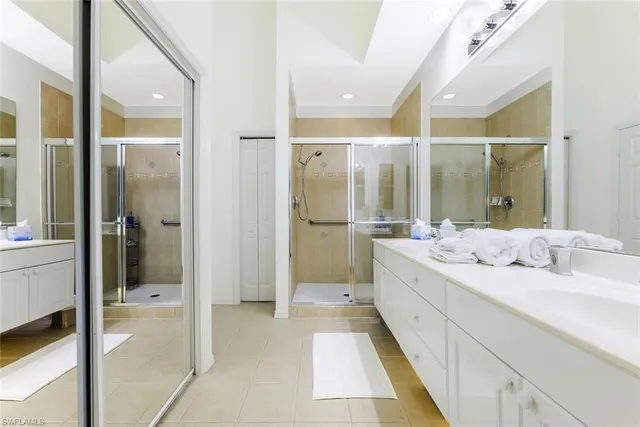 a bathroom with a granite countertop sink mirror and shower
