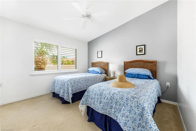 a bedroom with two beds and a window