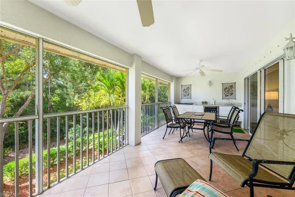 a dining room with furniture water view and a floor to ceiling window
