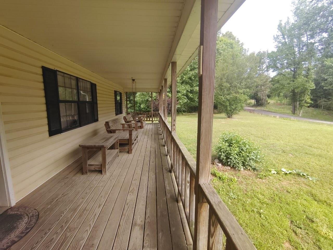 1475 Authur Byrd Road Pocahontas, TN 38061 - Photo 3 of 37 Expansive covered porch featuring wood flooring, wood railings, and a wood ceiling