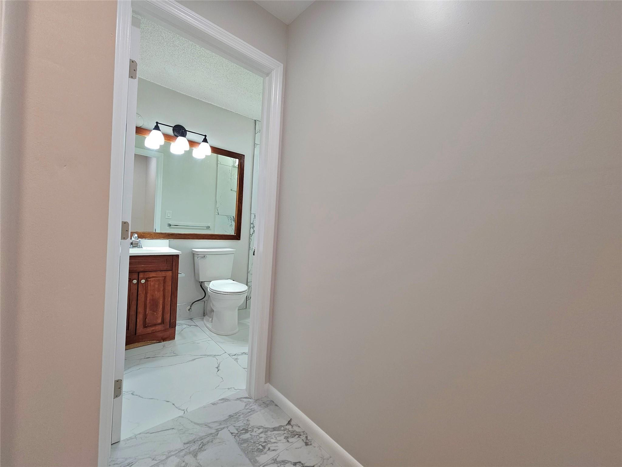 631 Lyons Road, Unit 12207 Pompano Beach, FL 33063 - Photo 13 of 30 ENTRANCE TO THE BATHROOM