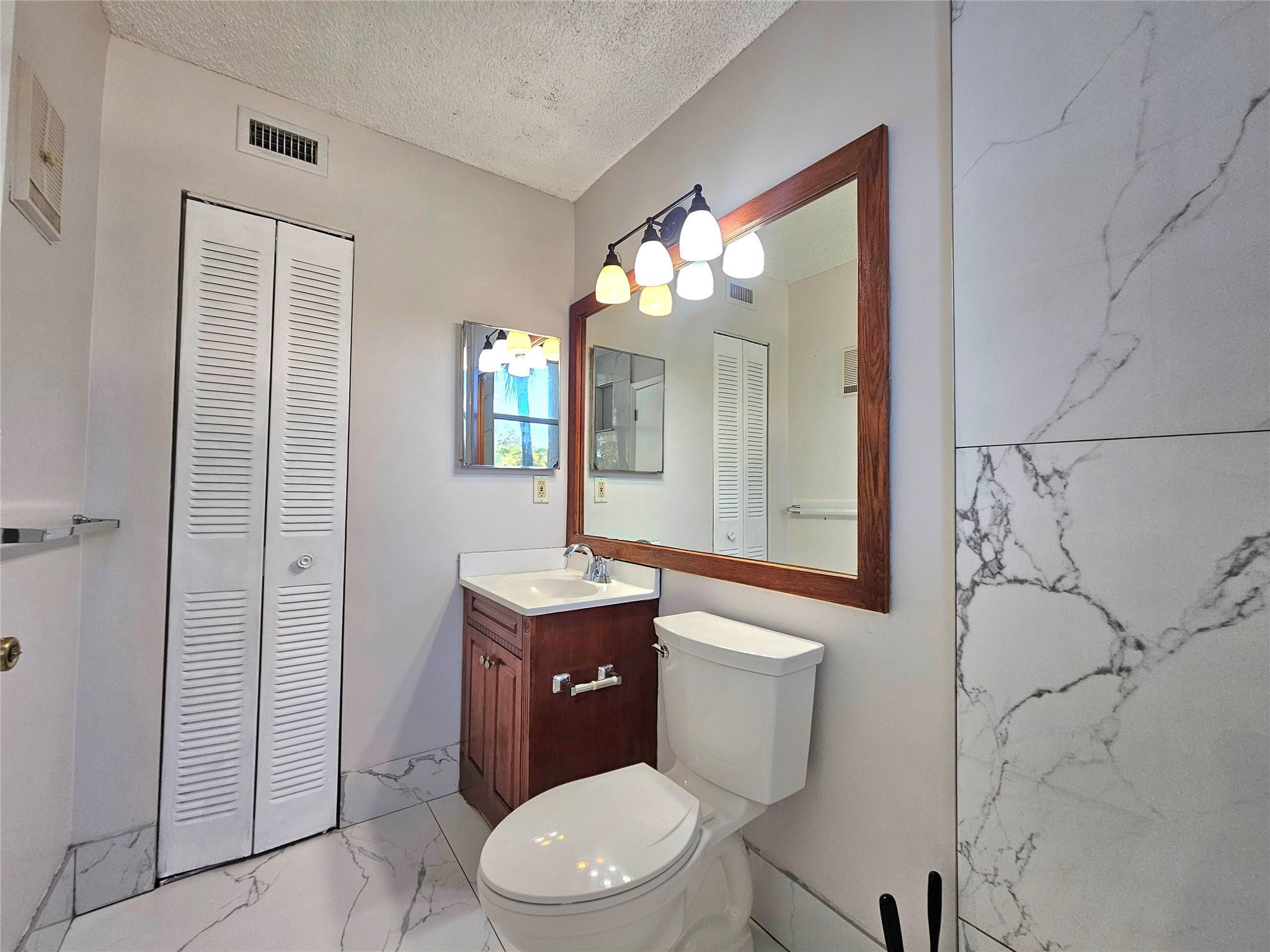 631 Lyons Road, Unit 12207 Pompano Beach, FL 33063 - Photo 14 of 30 LINEN CLOSET IN BATHROOM
