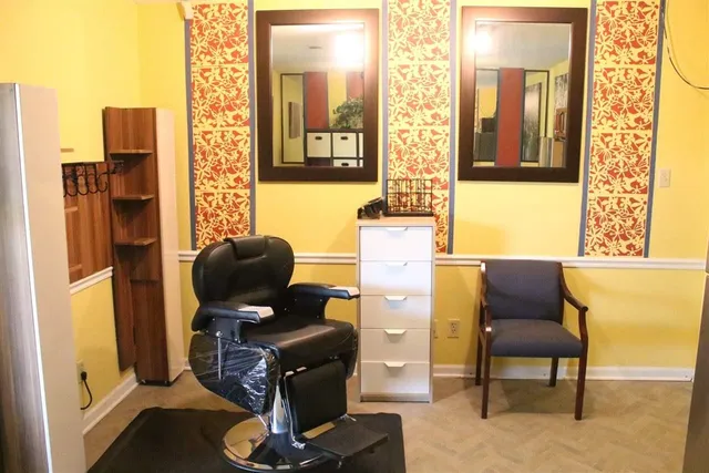 a view of a workspace with furniture and a window