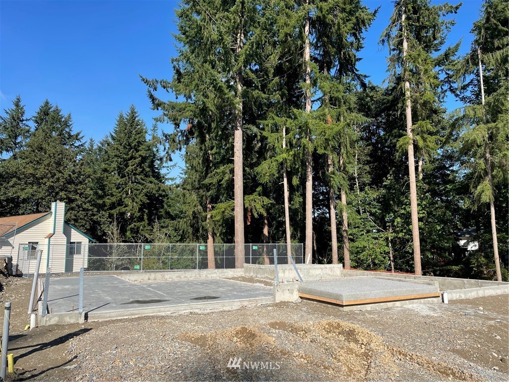 115 215th Street Southeast, Unit 6 Bothell, WA 98021 - Photo 2 of 18 a view of a house with a tree in front