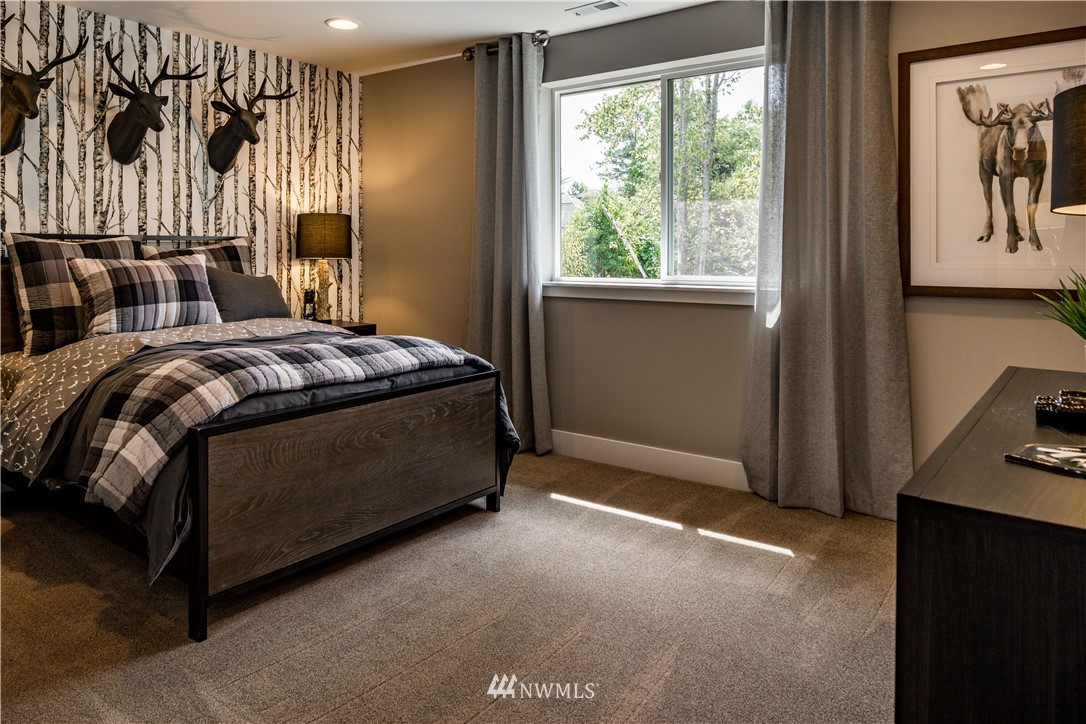 115 215th Street Southeast, Unit 6 Bothell, WA 98021 - Photo 15 of 18 a bed sitting in a room next to a window