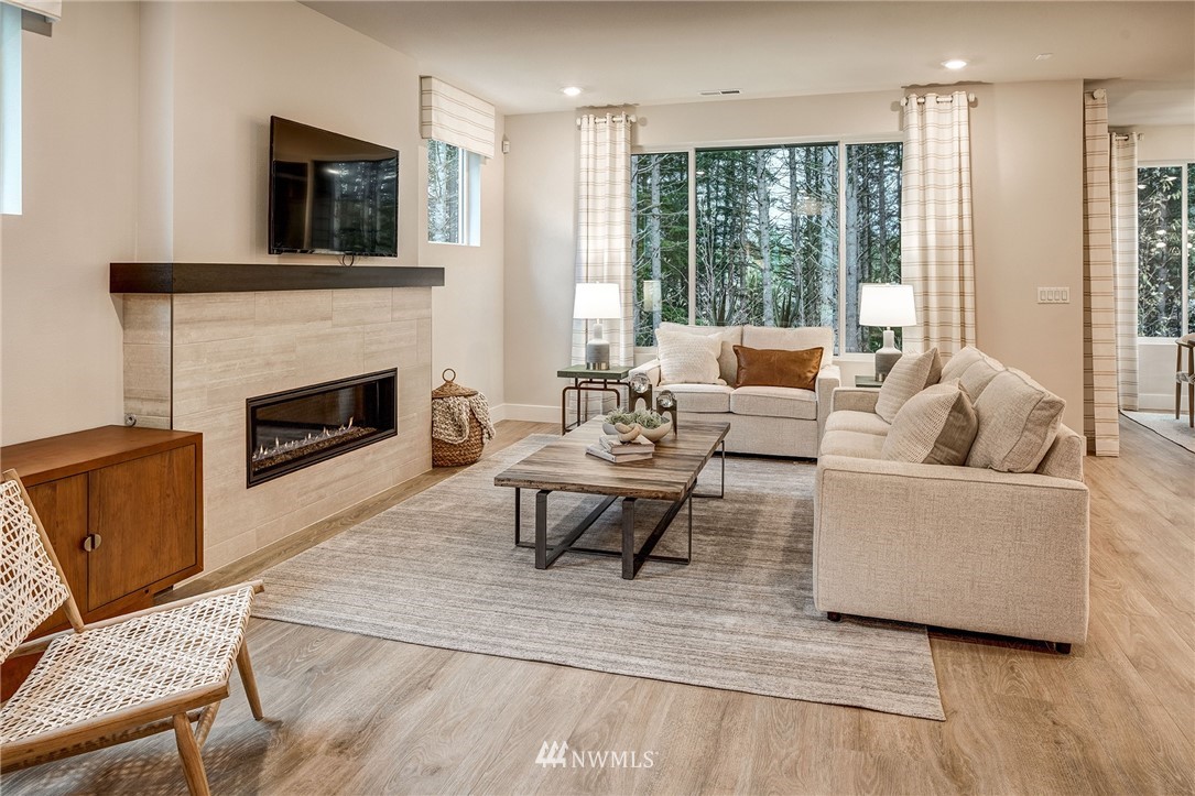 115 215th Street Southeast, Unit 6 Bothell, WA 98021 - Photo 8 of 18 a living room with furniture large window and a fireplace