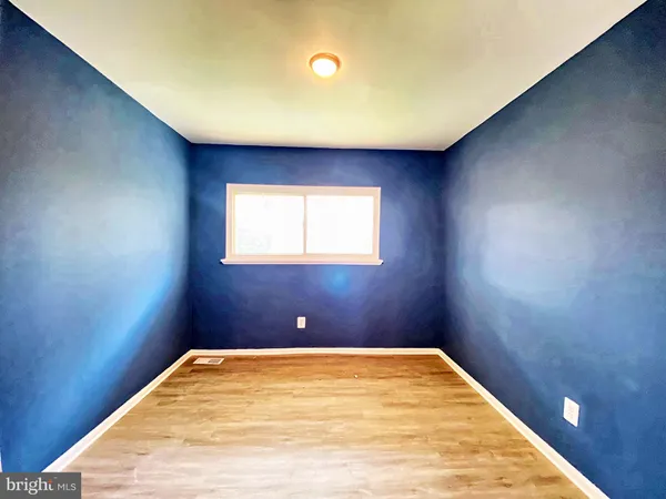 a view of a room with a wooden floor and a window