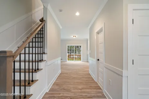 a view of a room with wooden floor chandelier and windows