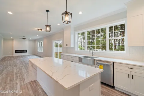 a view of a kitchen with a sink and large window