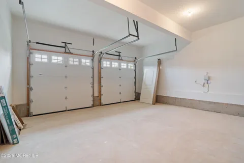 a view of a small space with wooden floor and a window