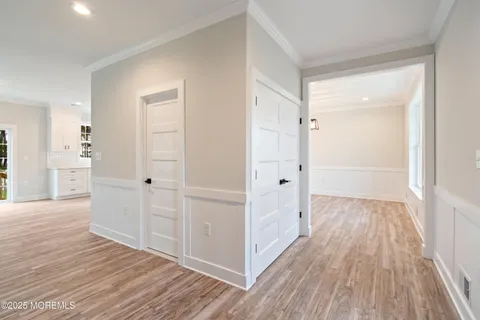a view of a hallway with wooden floor and entryway