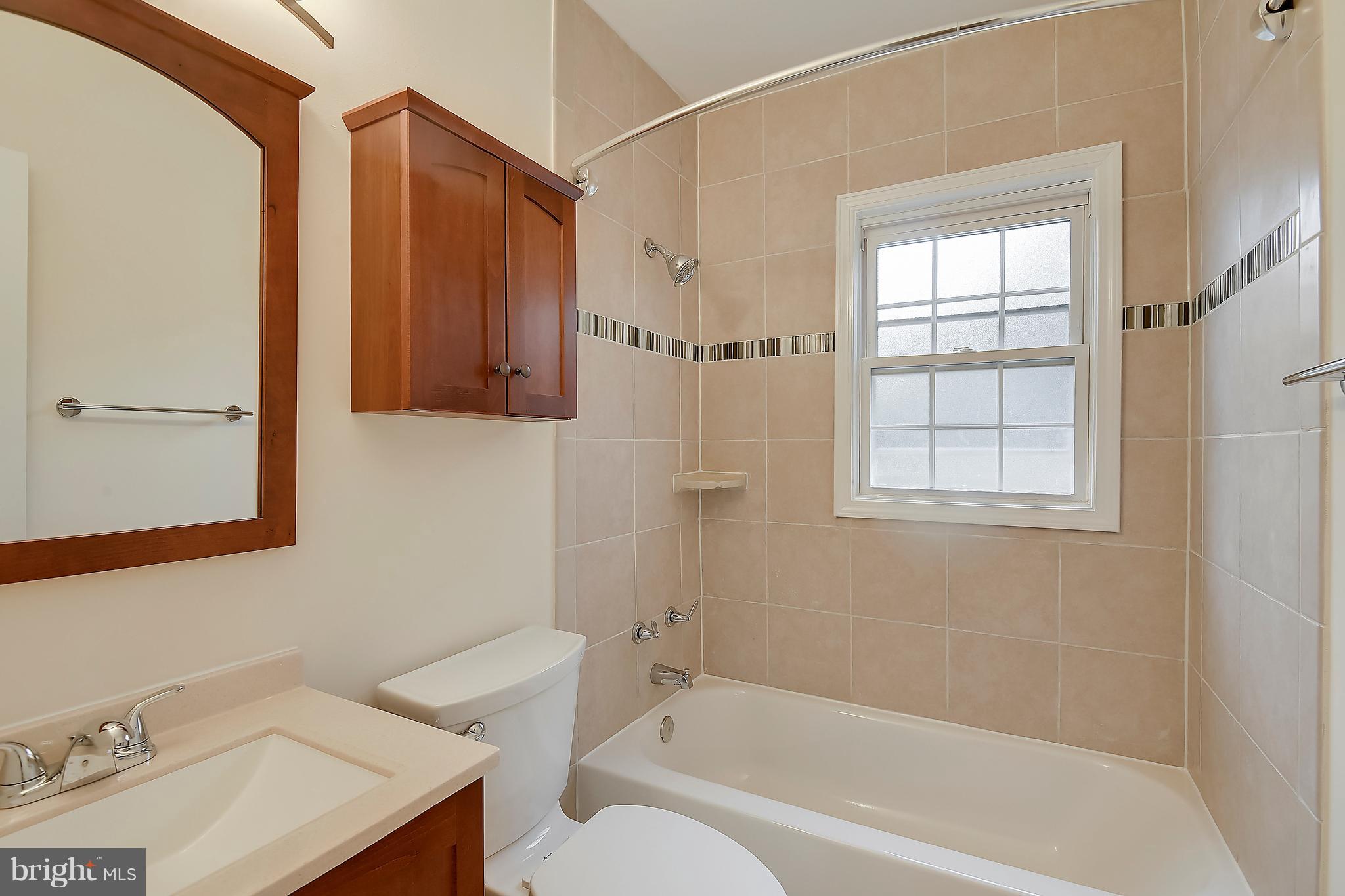 4023 18th Road North, Unit 1 Arlington, VA 22207 - Photo 13 of 30 a bathroom with a sink toilet and shower