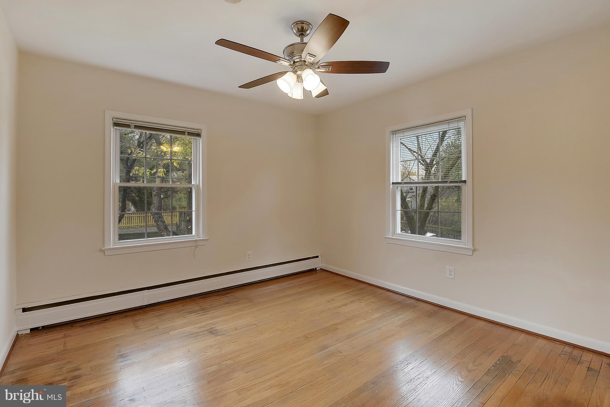 4023 18th Road North, Unit 1 Arlington, VA 22207 - Photo 14 of 30 a view of an empty room with wooden floor and a window