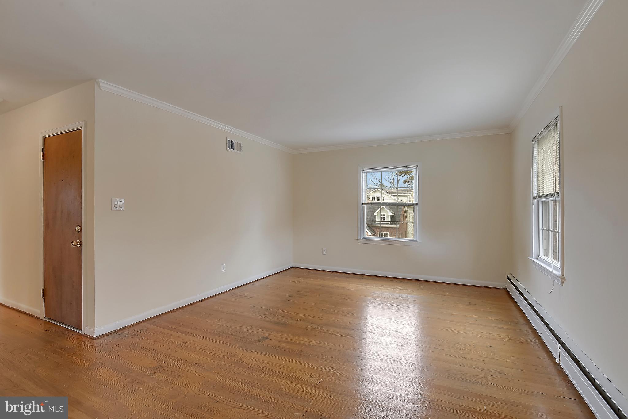 4023 18th Road North, Unit 1 Arlington, VA 22207 - Photo 2 of 30 an empty room with wooden floor and windows