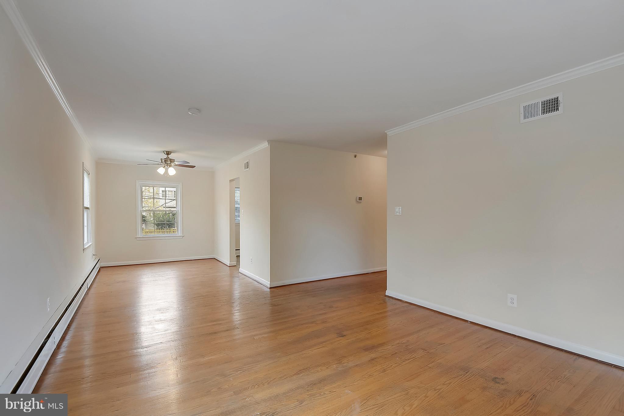 4023 18th Road North, Unit 1 Arlington, VA 22207 - Photo 4 of 30 a view of an empty room with wooden floor and a window