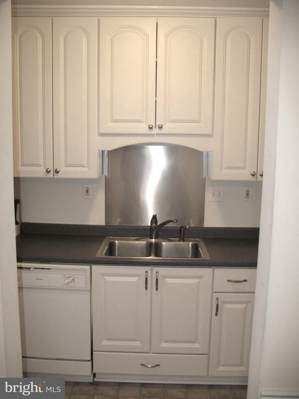 4023 18th Road North, Unit 1 Arlington, VA 22207 - Photo 7 of 30 a kitchen with granite countertop white cabinets and sink
