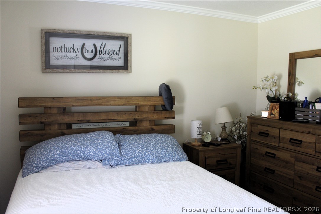 2038 Dunn Road Eastover, NC 28312 - Photo 19 of 29 a bedroom with a bed and a dresser in it