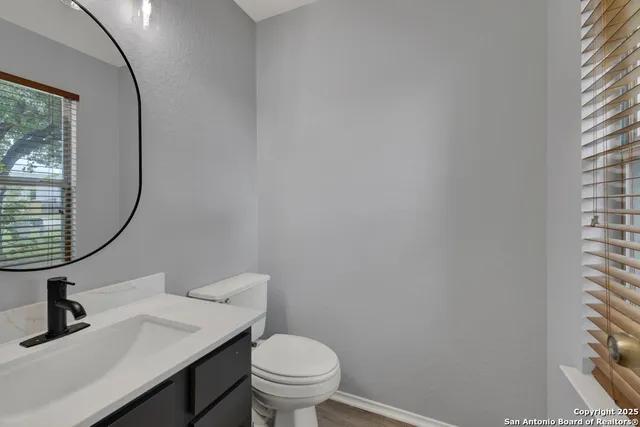 a bathroom with a toilet sink and mirror