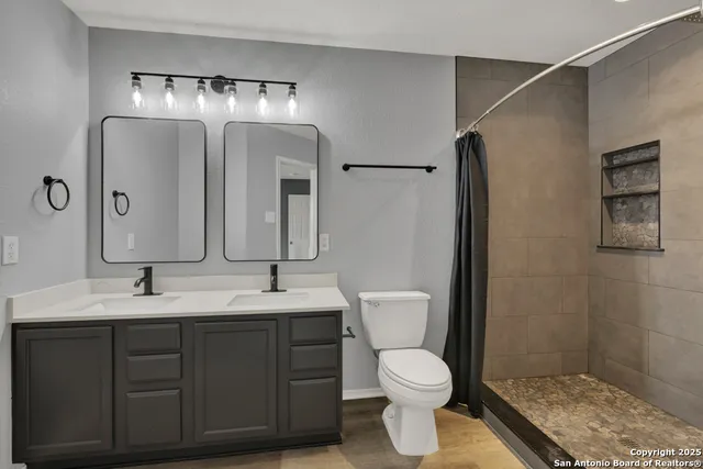 a bathroom with a toilet sink and mirror