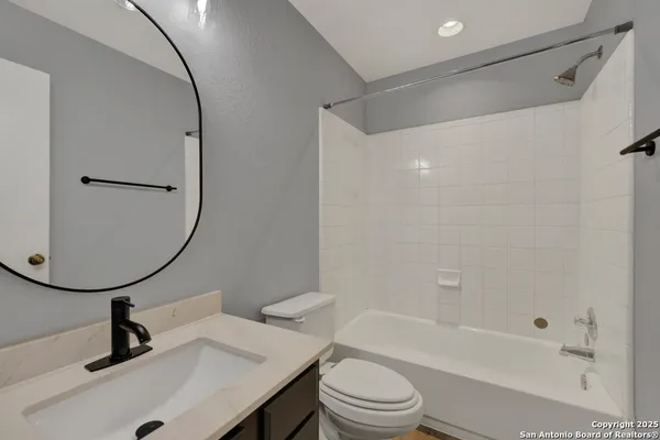 a bathroom with a sink a toilet and a mirror