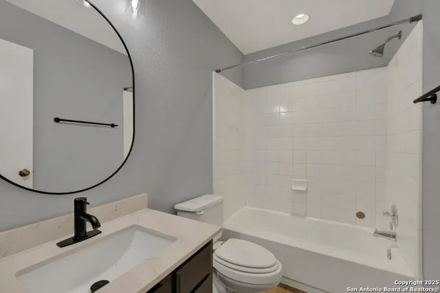a bathroom with a sink a toilet and a mirror