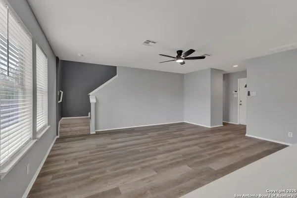 a view of a livingroom with a ceiling fan and window