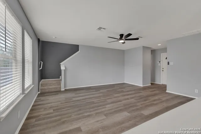 a view of a livingroom with a ceiling fan and window