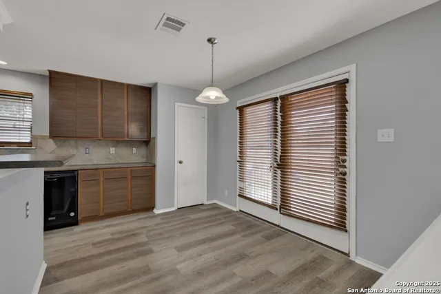 a kitchen with a refrigerator and window