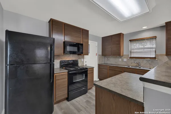 a kitchen with a refrigerator stove and sink