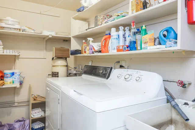 a spacious bedroom with a bed a table and chair