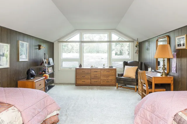 a bedroom with a bed and a lamp